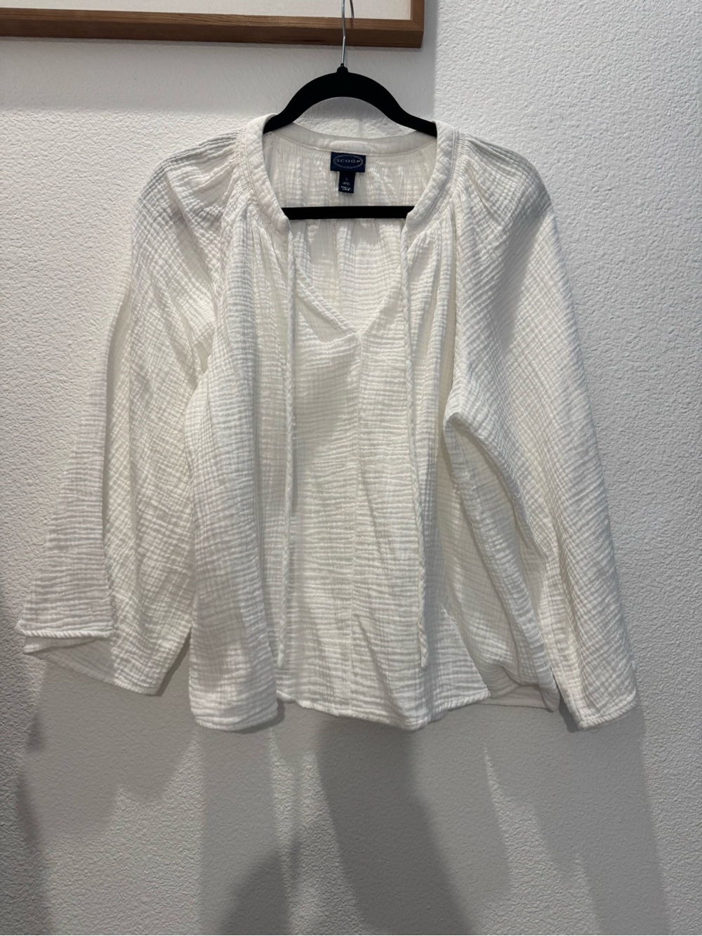 Scoop textured cotton gauze peasant blouse with a tie-neck detail.